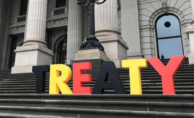 Letters in black yellow and red spelling out Treaty on the steps of Parliament House